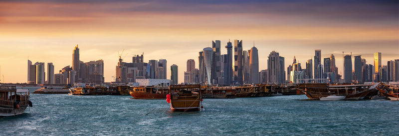 View of city at waterfront during sunset