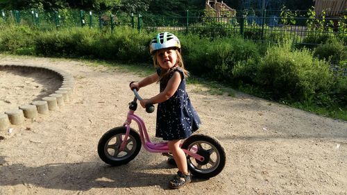 Portrait of girl riding bicycle outdoors