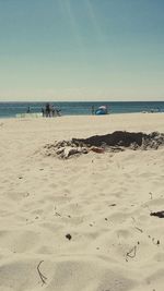 Scenic view of beach against blue sky