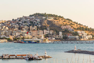 Townscape by sea against clear sky