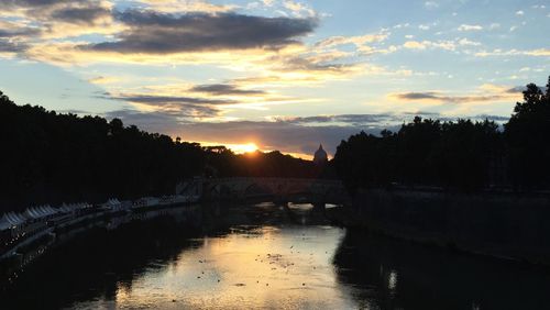 Scenic view of river against sky at sunset