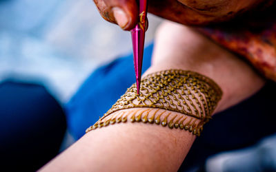 Cropped hand of woman holding equipment