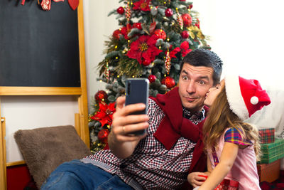 Young man photographing with mobile phone