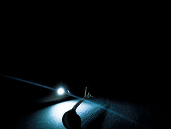 High angle view of illuminated lamp over black background