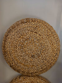 Close-up of wicker basket on table against wall