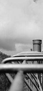 Close-up of metallic structure against sky