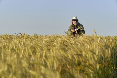 Rear view of woman walking on field