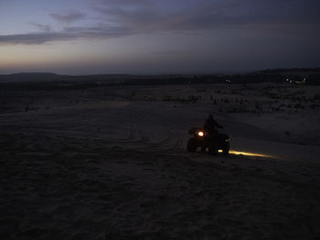 Scenic view of desert against sky at dusk