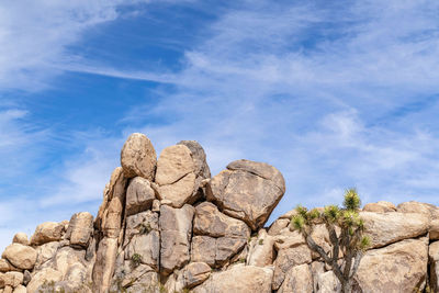 Low angle view of rock formation against sky