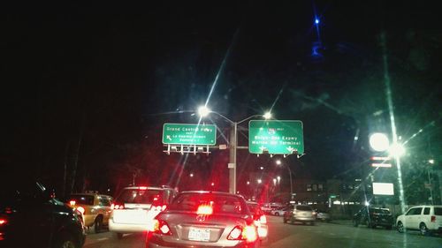 Cars on road in city at night