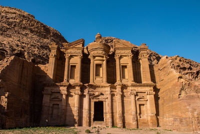 Low angle view of old ruins against clear blue sky