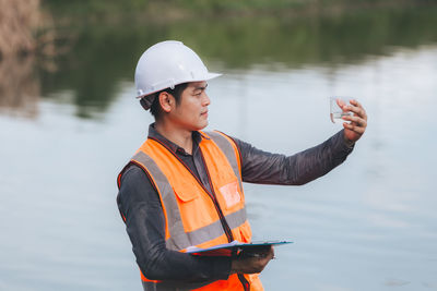 Rear view of man working at beach