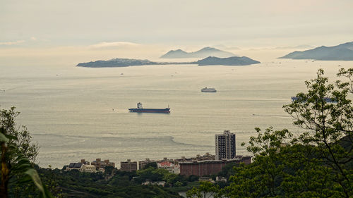 High angle view of sea and city against sky