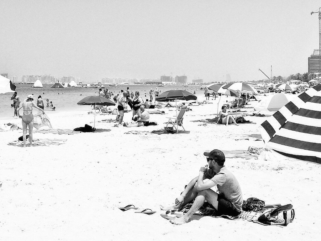 PEOPLE SITTING ON BEACH