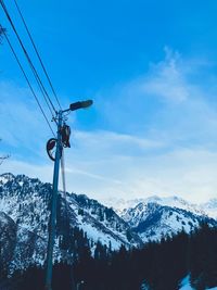 Snow covered mountain against blue sky