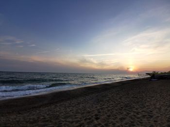 Scenic view of beach against sky during sunset