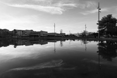 Reflection of buildings in lake against sky