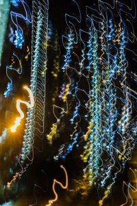 Close-up of illuminated water against sky at night