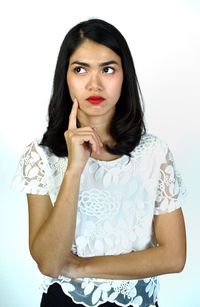 Portrait of beautiful woman against white background