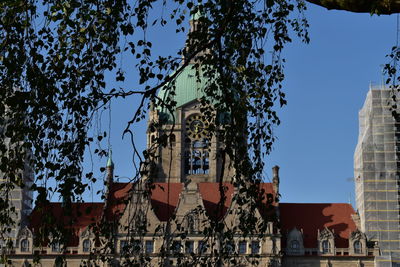 Low angle view of buildings against clear blue sky