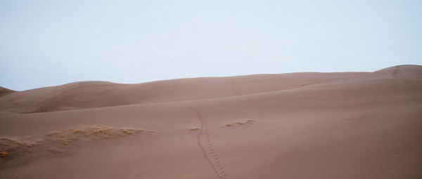 Scenic view of desert against clear sky