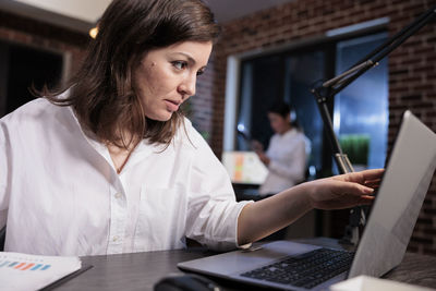 Businesswoman using laptop at office