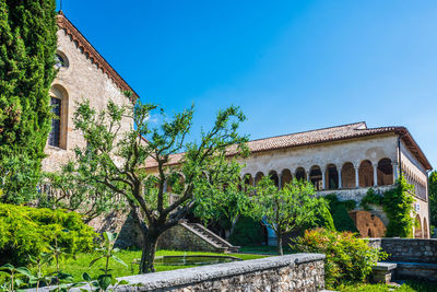 Low angle view of old building against clear blue sky