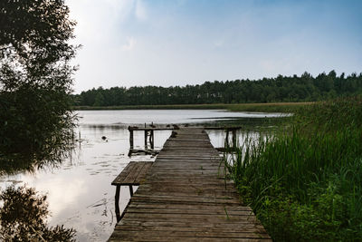 Pier over lake against sky