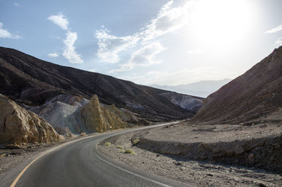 Road amidst mountains against sky