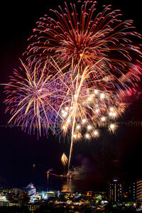 Low angle view of firework display at night