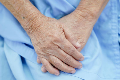 Cropped image of man holding hands