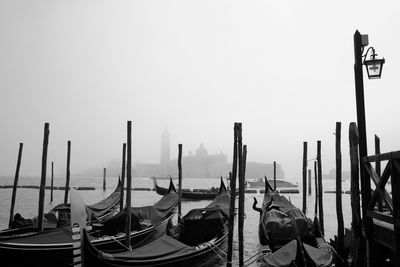 Gondolas on the river, boats moored in canal against clear sky