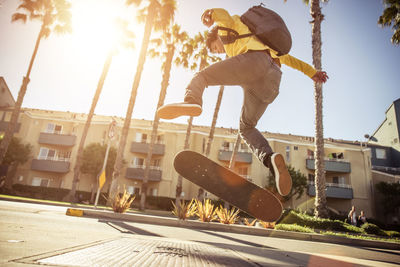 Low angle view of man jumping against built structure