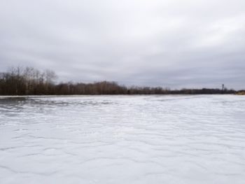 Scenic view of frozen landscape against sky