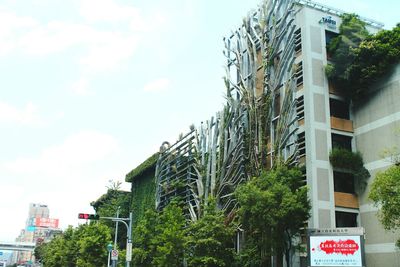 Low angle view of sign board against sky
