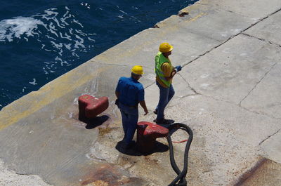 High angle view of people standing in water