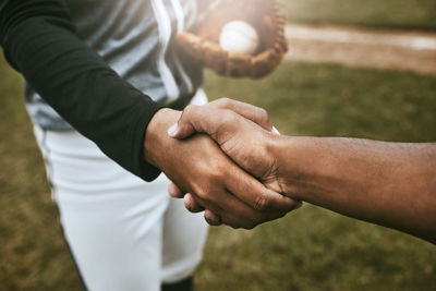 Cropped image of couple holding hands