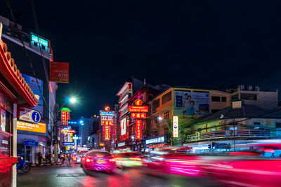 Cars on city street at night