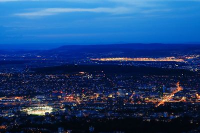 High angle view of illuminated city against sky at night