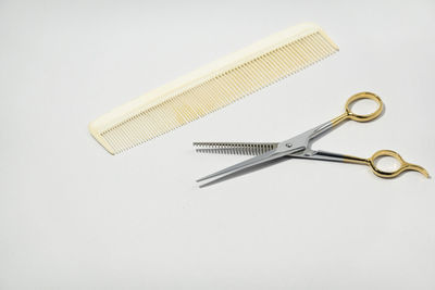 High angle view of cross on table against white background