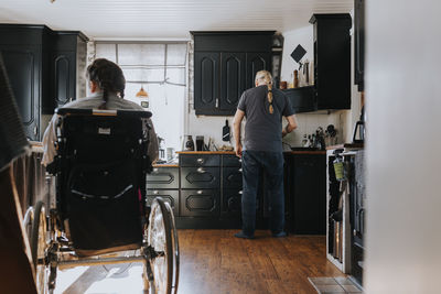 Father with daughter in kitchen