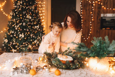 Portrait of woman holding christmas tree