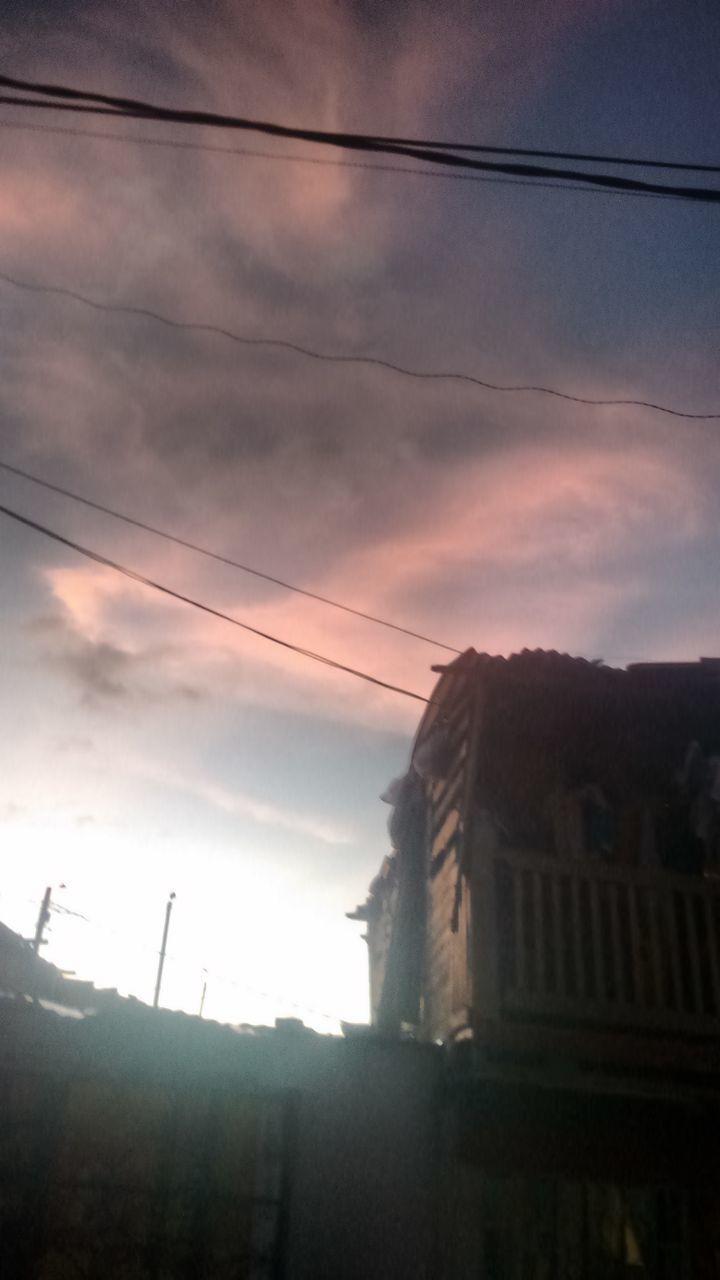 architecture, building exterior, built structure, sky, power line, low angle view, cable, house, cloud - sky, electricity pylon, residential structure, cloud, building, silhouette, residential building, electricity, dusk, cloudy, outdoors, no people