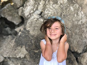 Portrait of a smiling girl on rock