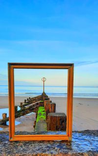 Built structure on beach against sky