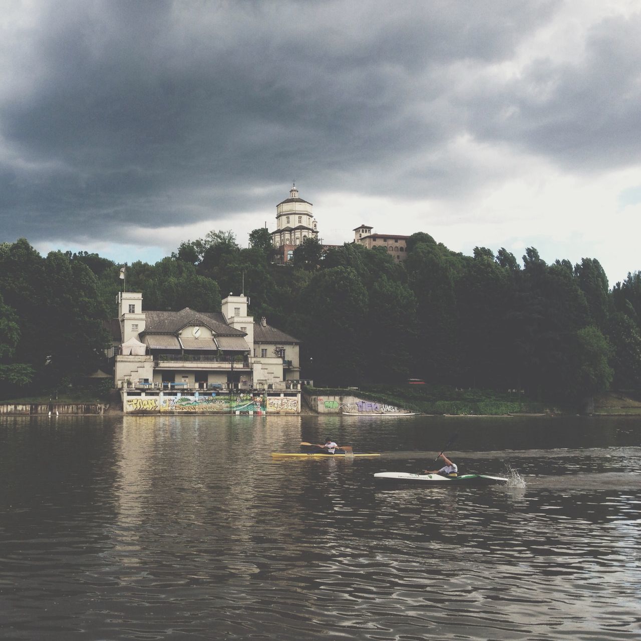 sky, water, cloud - sky, cloudy, waterfront, architecture, built structure, building exterior, nautical vessel, transportation, boat, cloud, tree, mode of transport, weather, river, overcast, lake, nature, rippled