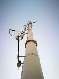 Low angle view of communications tower against clear sky