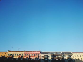 Low angle view of built structure against clear blue sky