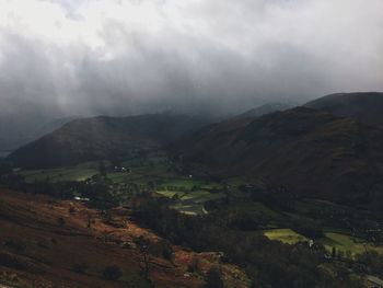 Scenic view of agricultural field against storm clouds