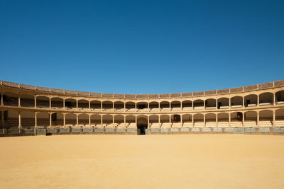 Low angle view of historical building against clear blue sky